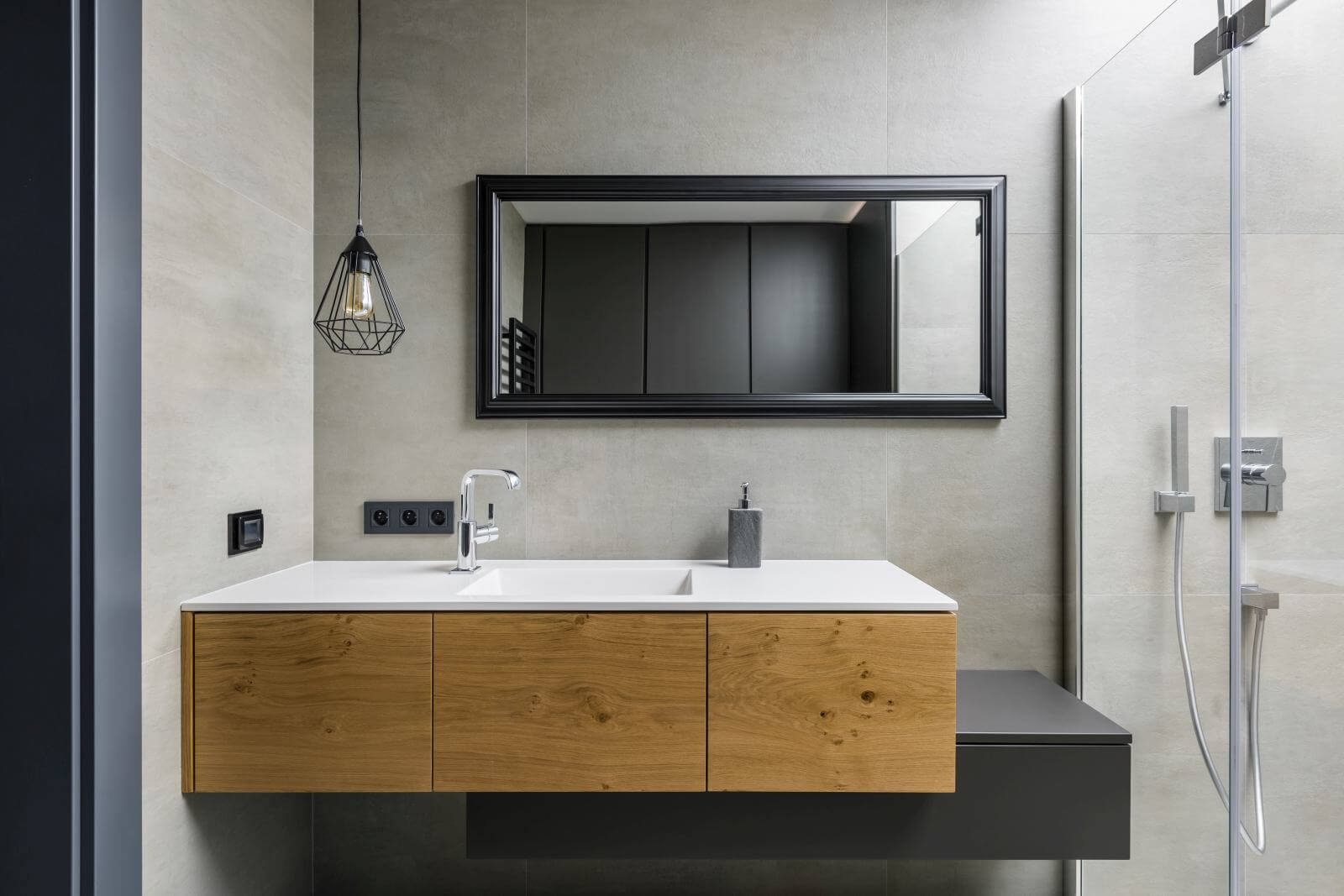 Gray bathroom with modern countertop basin, mirror and shower