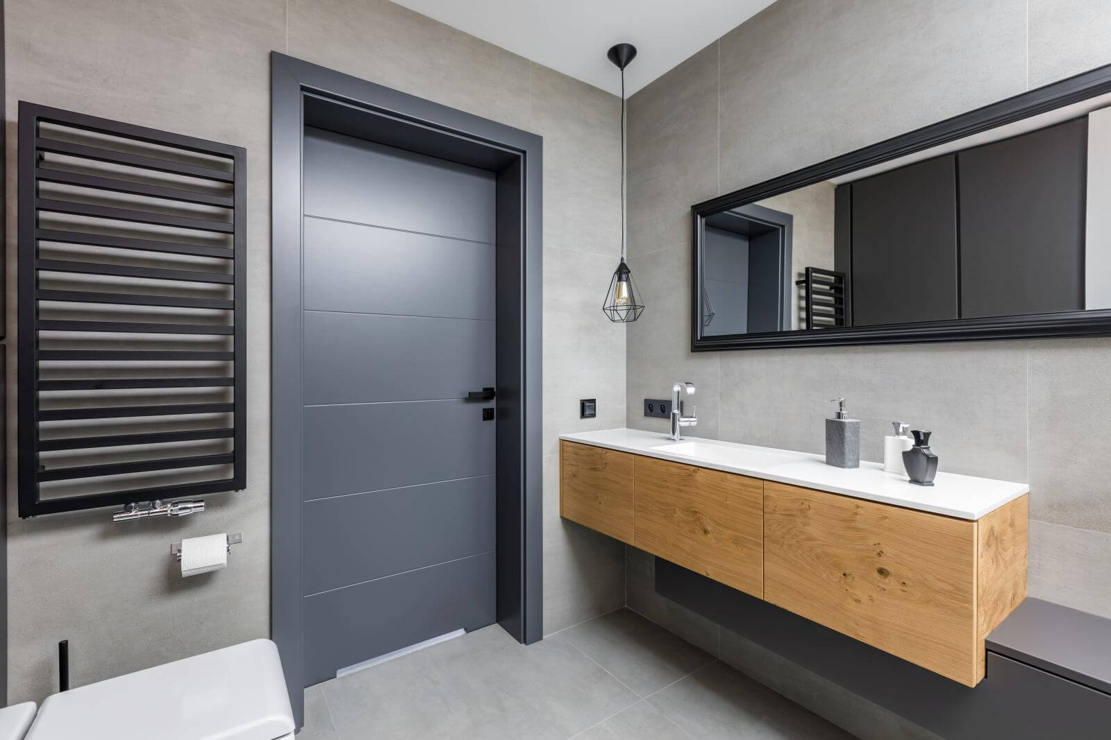 Dark and elegant bathroom with countertop basin and mirror