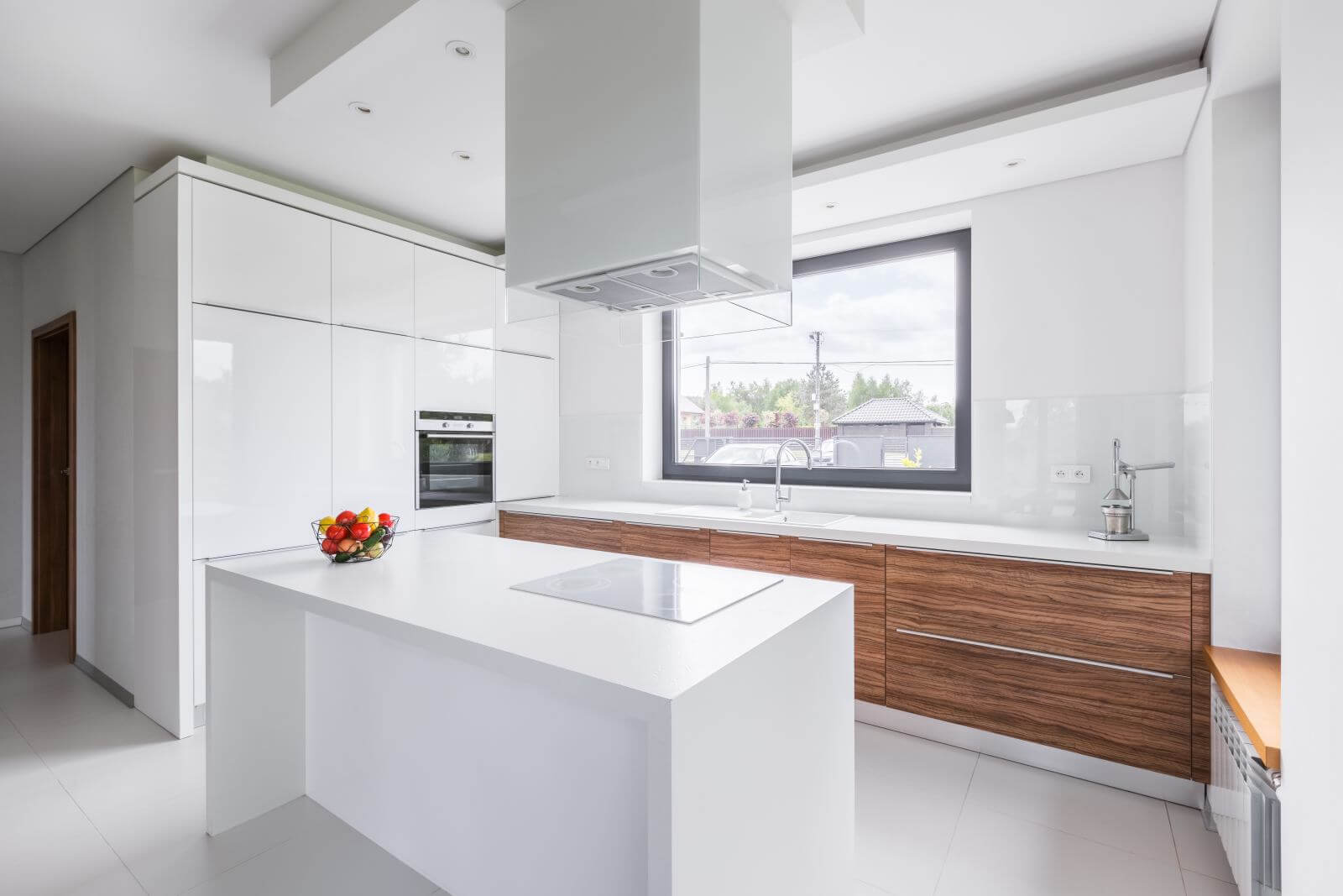 Modern, white kitchen with island and long countertop