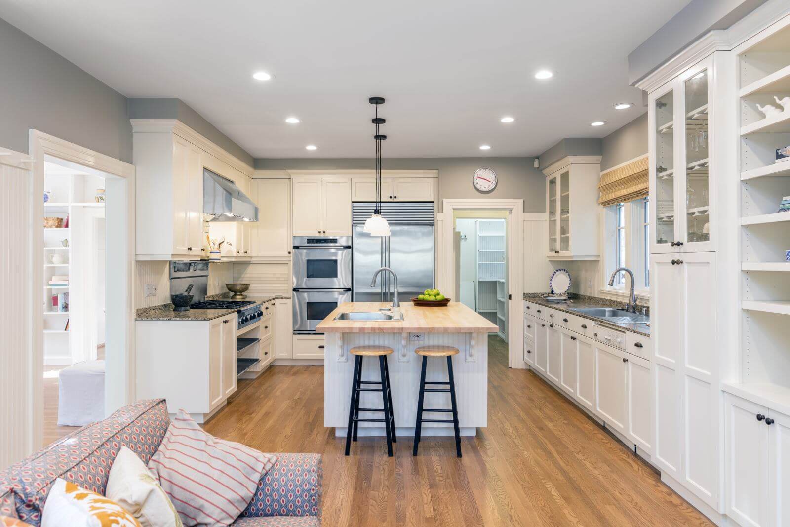 Amazing Luxury Kitchen Interior in white with wooden floor and kitchen island.
