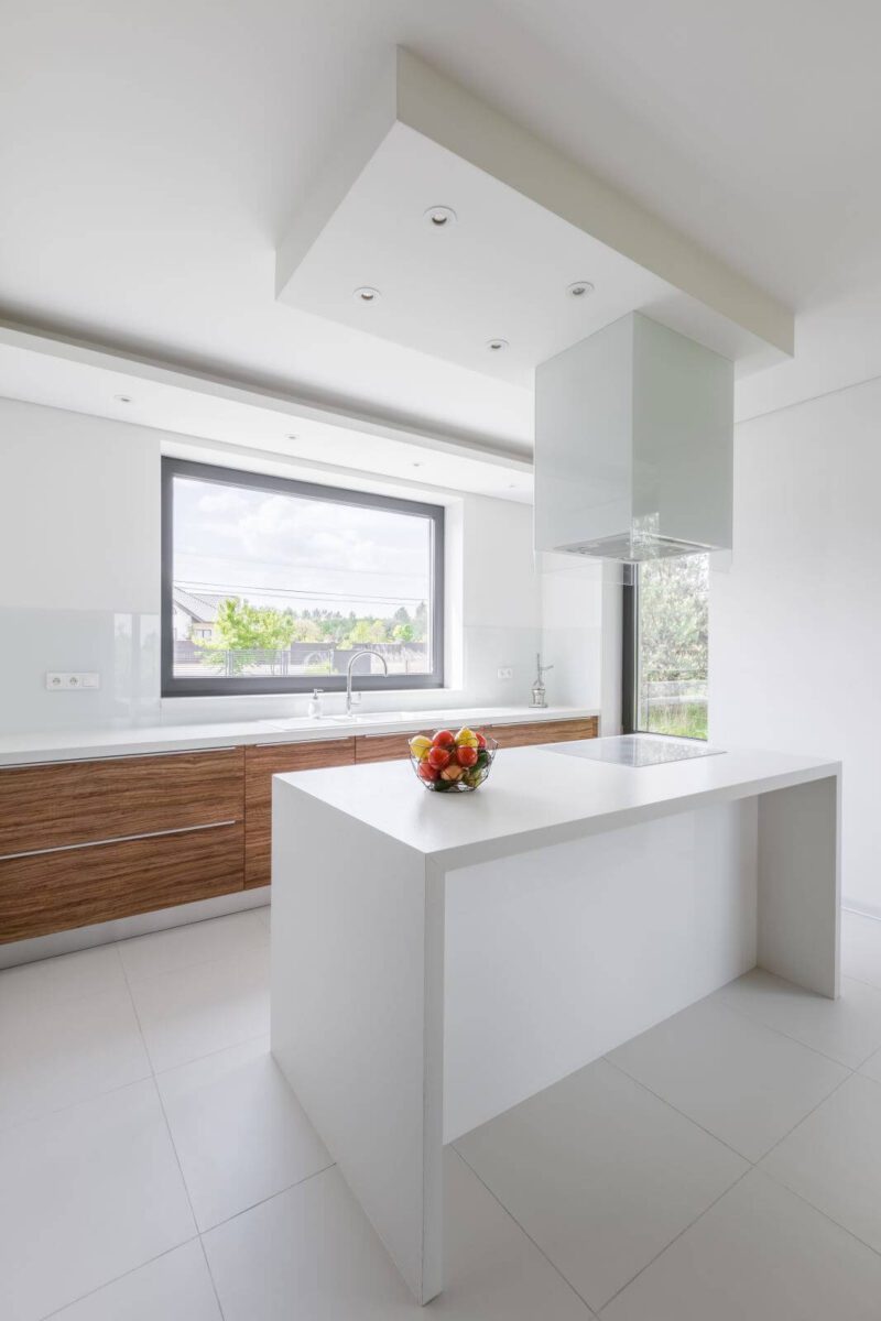 Modern, white kitchen with island and wooden cupboards