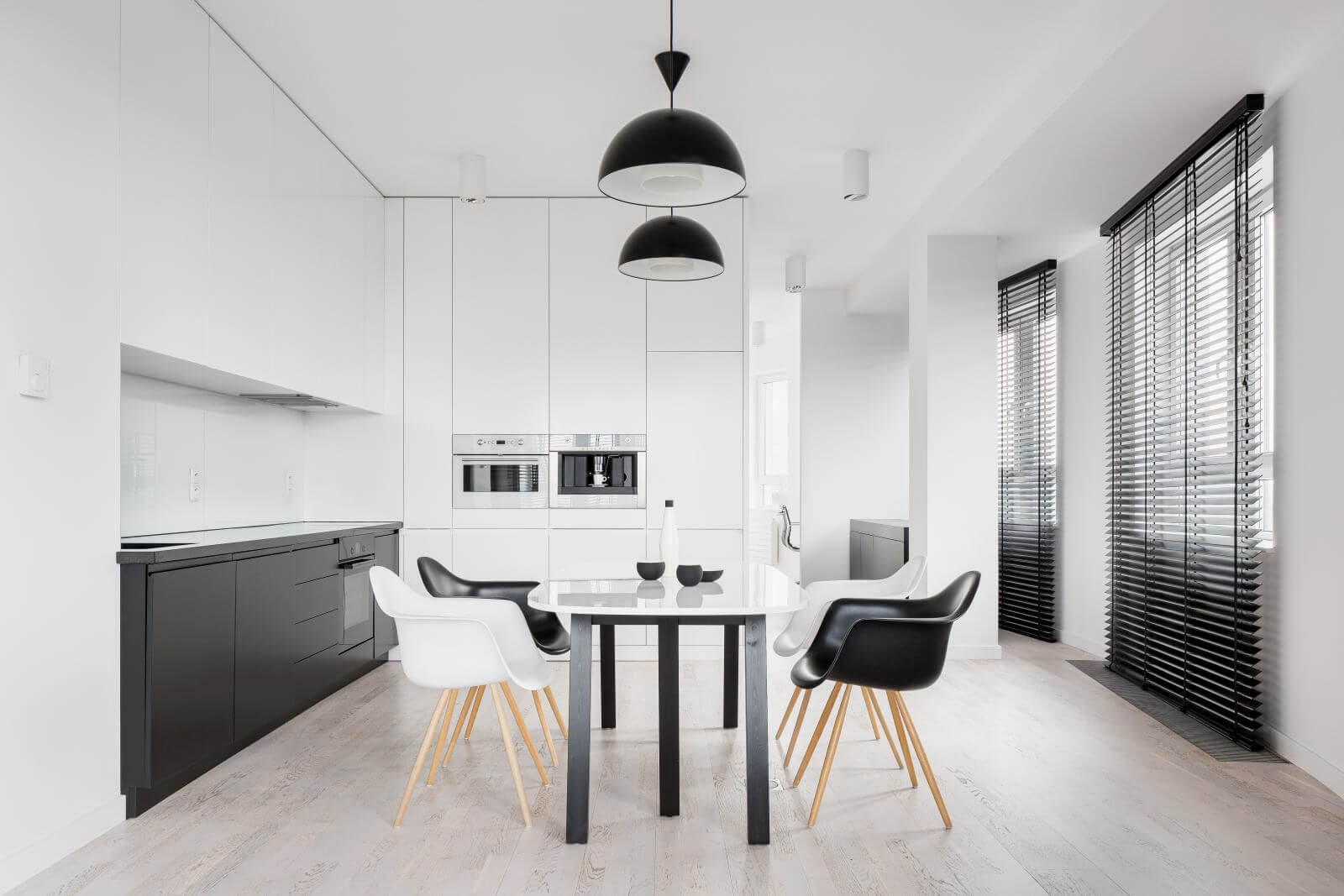 Spacious kitchen interior in black and white with dining area