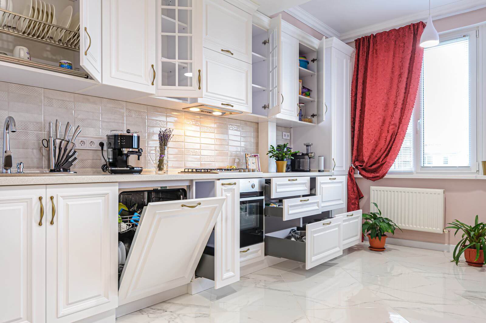 Simple and luxury modern white kitchen interior, some doors and drawers are open